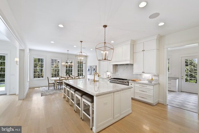 9850 Jerry Ln, Vienna, VA 22180 - kitchen featuring a chandelier, recessed lighting, healthy amount of natural light, backsplash, and white cabinets
