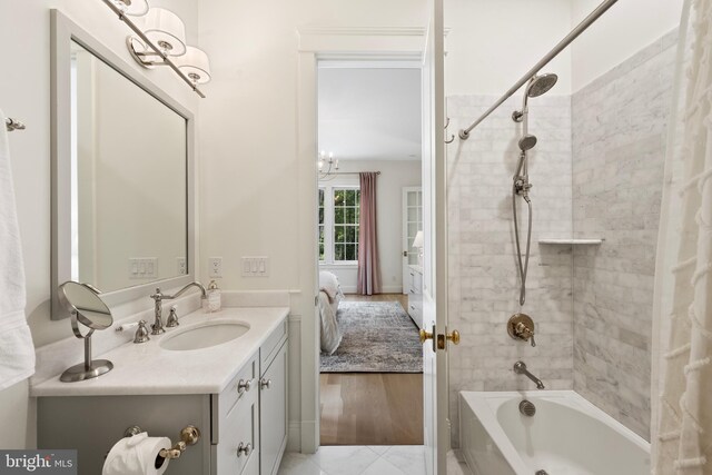 9850 Jerry Ln, Vienna, VA 22180 - ensuite bathroom featuring vanity, shower / washtub combination, and a chandelier