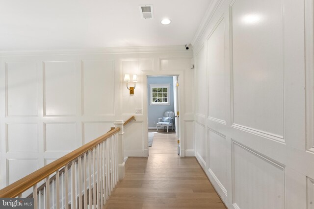 9850 Jerry Ln, Vienna, VA 22180 - hall featuring a decorative wall, an upstairs landing, light wood-style floors, crown molding, and recessed lighting