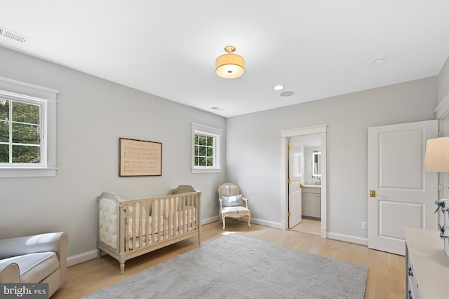 9850 Jerry Ln, Vienna, VA 22180 - bedroom with light wood finished floors, baseboards, recessed lighting, and a nursery area