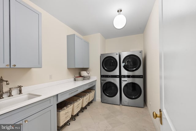 9850 Jerry Ln, Vienna, VA 22180 - laundry room featuring estacked washer and dryer, cabinet space, and baseboards
