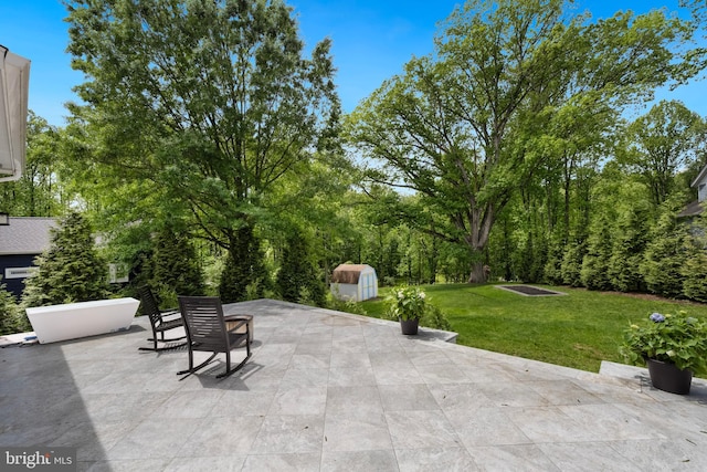 9850 Jerry Ln, Vienna, VA 22180 - view of patio featuring a storage unit and an outbuilding