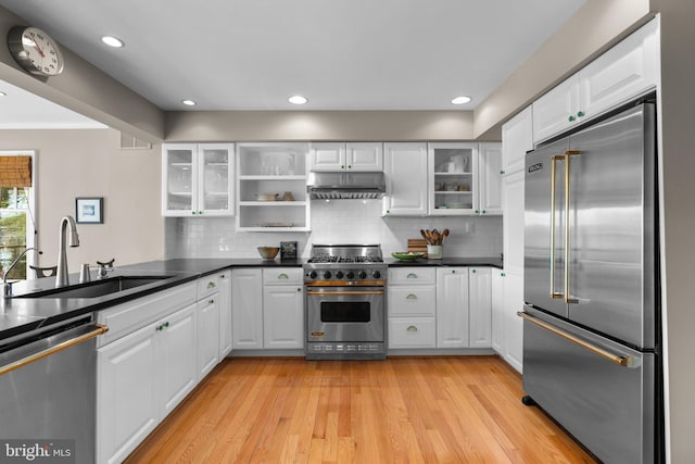 735 Dividing Rd, Severna Park, MD 21146 - kitchen featuring white cabinetry, light wood-style flooring, a sink, under cabinet range hood, and high end appliances