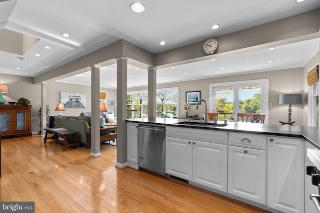 735 Dividing Rd, Severna Park, MD 21146 - kitchen with white cabinetry, a sink, light wood-style floors, dishwasher, and decorative columns