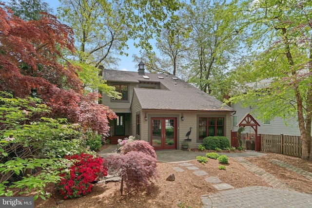 735 Dividing Rd, Severna Park, MD 21146 - rear view of property featuring fence, a chimney, a shingled roof, and french doors