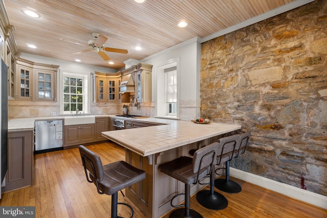 65 W Green St, Westminster, MD 21157 - kitchen featuring ornamental molding, a peninsula, light wood-style floors, a kitchen breakfast bar, and stainless steel appliances