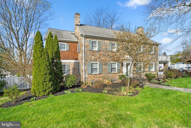 65 W Green St, Westminster, MD 21157 - view of front of home with fence, a front yard, stone siding, a chimney, and a shingled roof