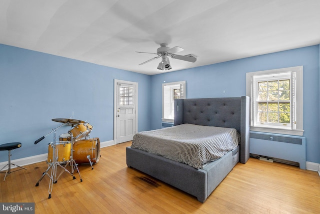 65 W Green St, Westminster, MD 21157 - bedroom with radiator heating unit, baseboards, multiple windows, and wood finished floors