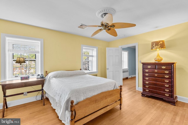 65 W Green St, Westminster, MD 21157 - bedroom featuring radiator, multiple windows, baseboards, and light wood-type flooring