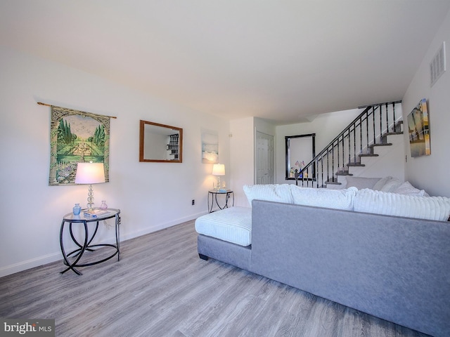 112 Jackson Ave, New Castle, DE 19720 - living area featuring visible vents, stairway, wood finished floors, and baseboards