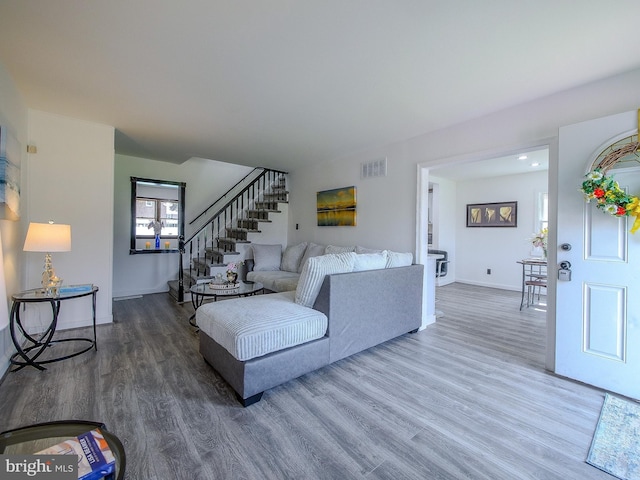 112 Jackson Ave, New Castle, DE 19720 - living area with wood finished floors, visible vents, stairway, and baseboards