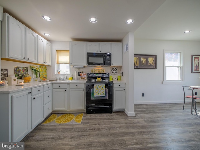 112 Jackson Ave, New Castle, DE 19720 - kitchen featuring black appliances, light countertops, white cabinets, and recessed lighting