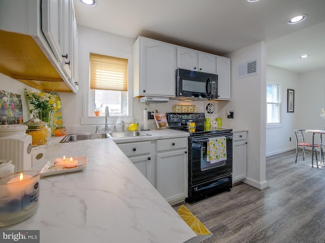 112 Jackson Ave, New Castle, DE 19720 - kitchen featuring visible vents, black appliances, white cabinets, and a sink