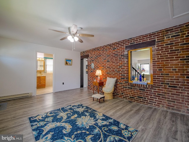 112 Jackson Ave, New Castle, DE 19720 - sitting room featuring wood finished floors, ceiling fan, brick wall, and a baseboard radiator
