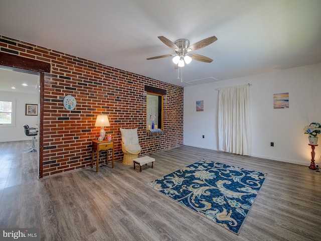 112 Jackson Ave, New Castle, DE 19720 - sitting room featuring baseboards, wood finished floors, ceiling fan, and brick wall