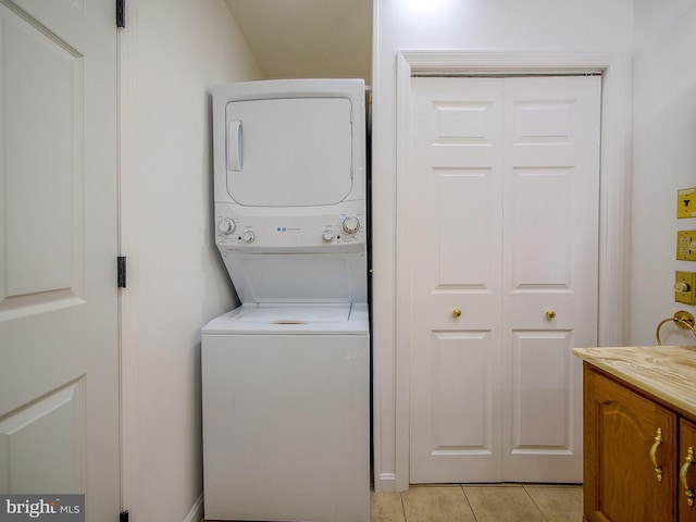 112 Jackson Ave, New Castle, DE 19720 - clothes washing area featuring stacked washer / dryer, light tile patterned floors, and laundry area