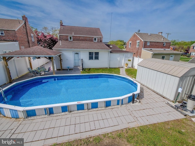 112 Jackson Ave, New Castle, DE 19720 - outdoor pool with a patio, a gazebo, a shed, an outbuilding, and a fenced backyard