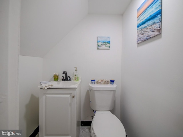 112 Jackson Ave, New Castle, DE 19720 - bathroom featuring toilet, a sink, and lofted ceiling
