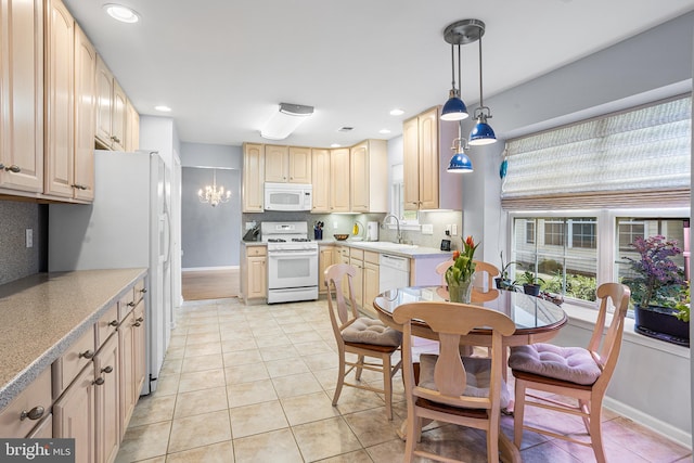 kitchen featuring backsplash, pendant lighting, white appliances, and light tile patterned floors