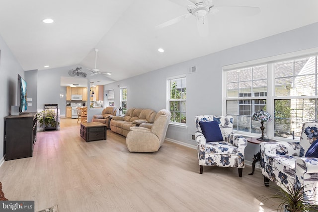 living room with light wood-style flooring, baseboards, vaulted ceiling, and ceiling fan