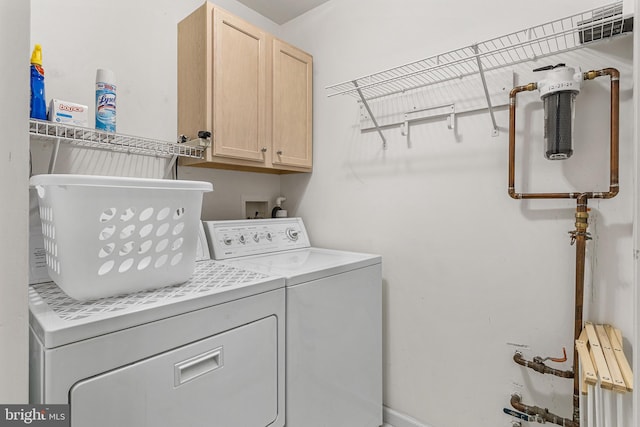 washroom featuring washer and dryer and cabinet space