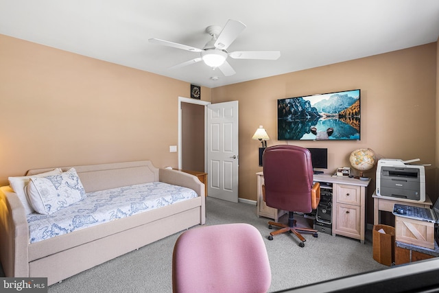 carpeted bedroom featuring baseboards and a ceiling fan