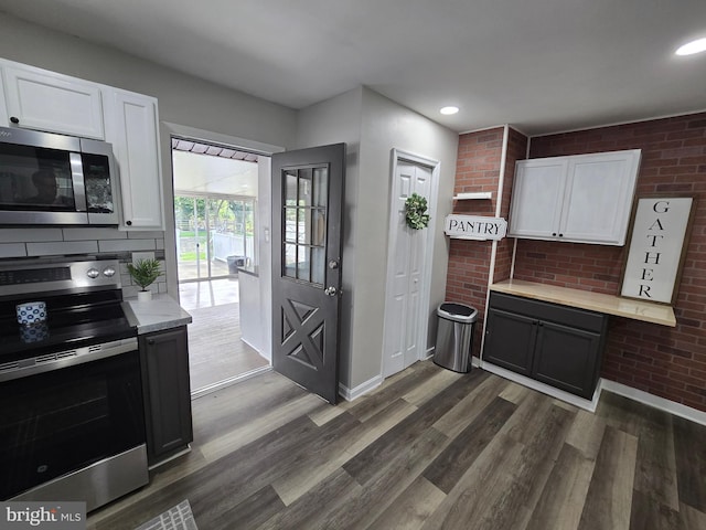 401 Timberline Dr, Mount Laurel, NJ 08054 - kitchen with appliances with stainless steel finishes, light countertops, white cabinetry, dark wood-type flooring, and baseboards