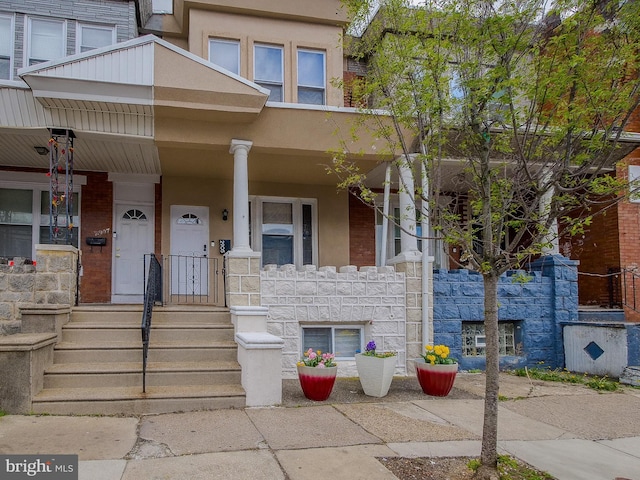 2905 Memphis St, Philadelphia, PA 19134 - view of property featuring stone siding, covered porch, and stucco siding