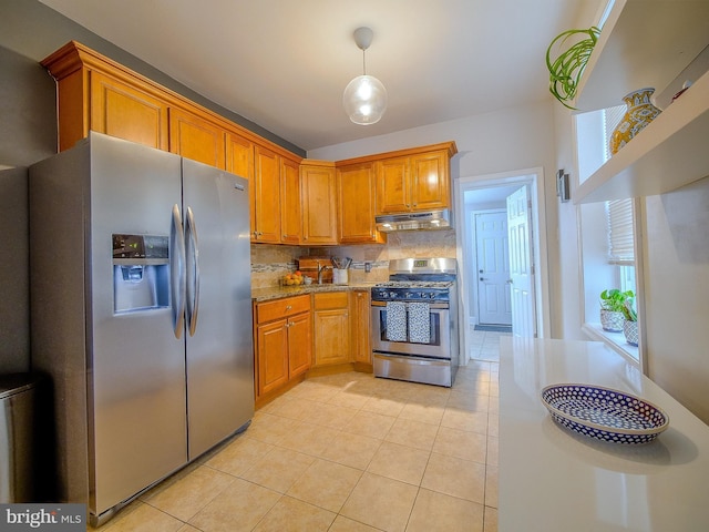 2905 Memphis St, Philadelphia, PA 19134 - kitchen with decorative backsplash, appliances with stainless steel finishes, light stone countertops, under cabinet range hood, and light tile patterned floors