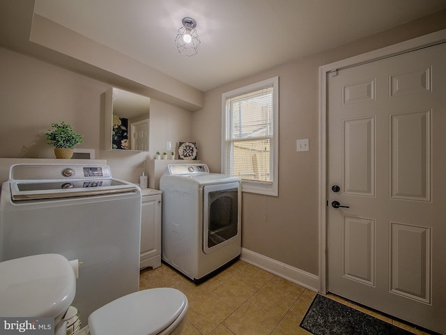 2905 Memphis St, Philadelphia, PA 19134 - laundry room with light tile patterned floors, washing machine and clothes dryer, baseboards, and laundry area