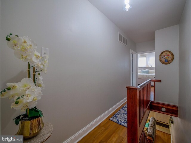 2905 Memphis St, Philadelphia, PA 19134 - corridor featuring wood finished floors, visible vents, baseboards, and an upstairs landing