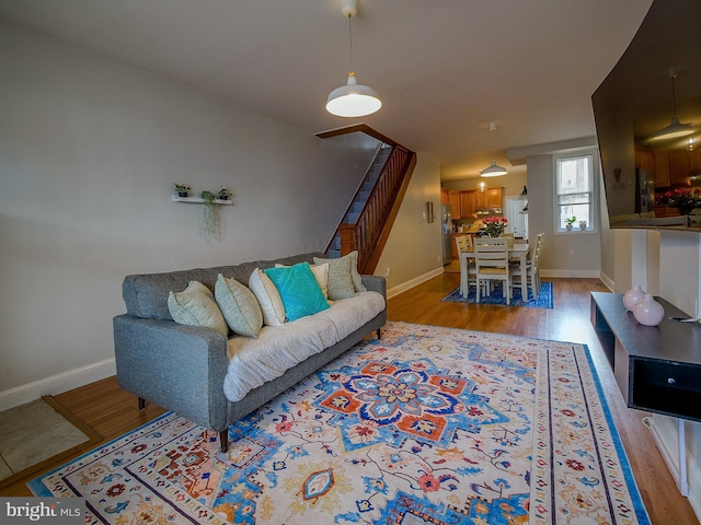 2905 Memphis St, Philadelphia, PA 19134 - living area with baseboards, light wood-style floors, and stairway