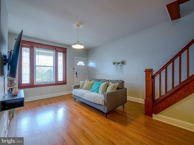 2905 Memphis St, Philadelphia, PA 19134 - living room with stairway, baseboards, visible vents, and light wood-style flooring