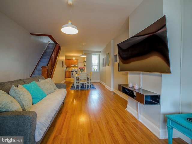 2905 Memphis St, Philadelphia, PA 19134 - living room featuring baseboards, stairs, and light wood-style flooring