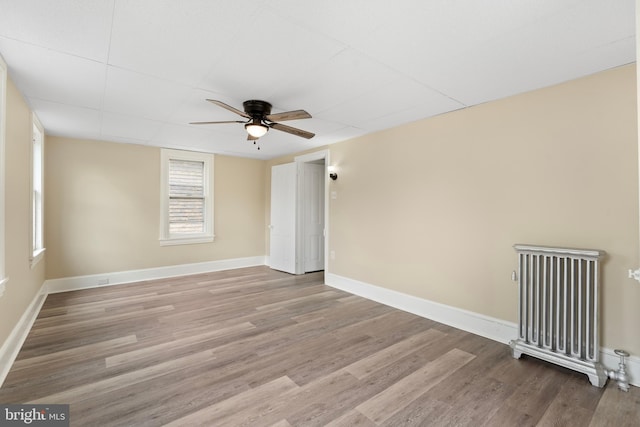 35 Walnut St, Salem, NJ 08079 - empty room with ceiling fan, radiator heating unit, wood finished floors, and baseboards