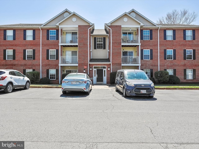 view of building exterior with uncovered parking
