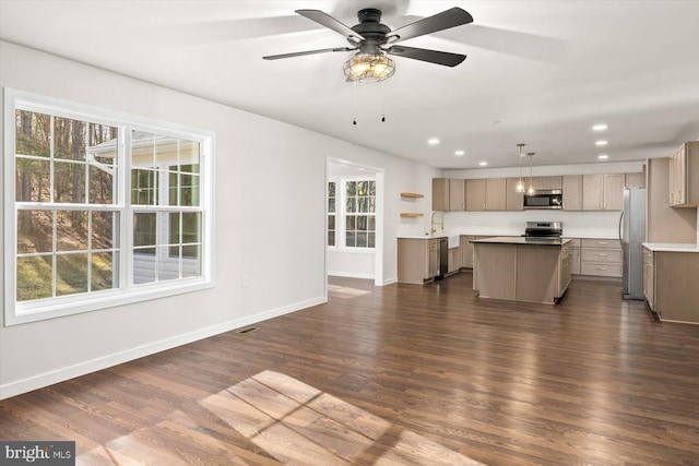 unfurnished living room with dark wood-style flooring, baseboards, recessed lighting, visible vents, and ceiling fan