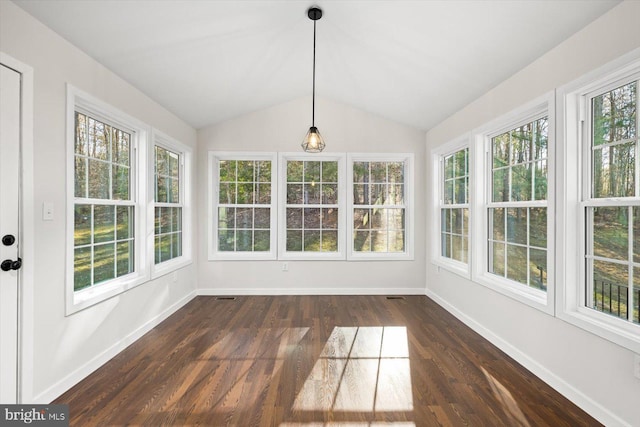 unfurnished sunroom featuring wood finished floors, visible vents, baseboards, and vaulted ceiling