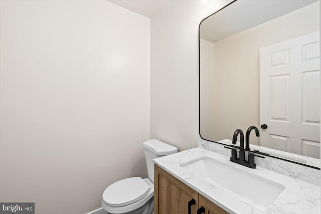bathroom with toilet and vanity