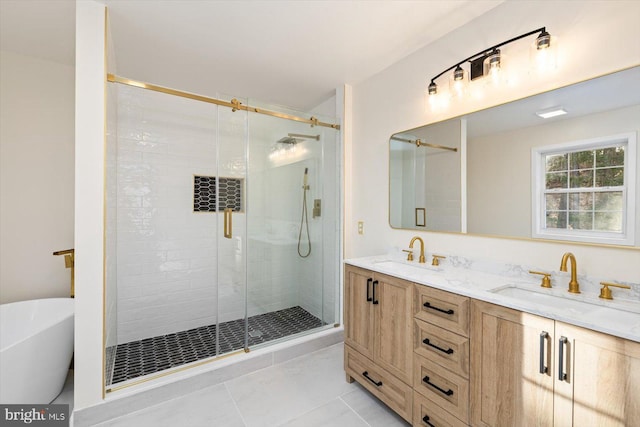 full bathroom with a stall shower, double vanity, a sink, and a freestanding bath