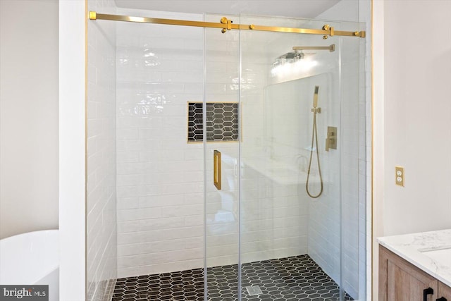full bathroom with a stall shower and vanity