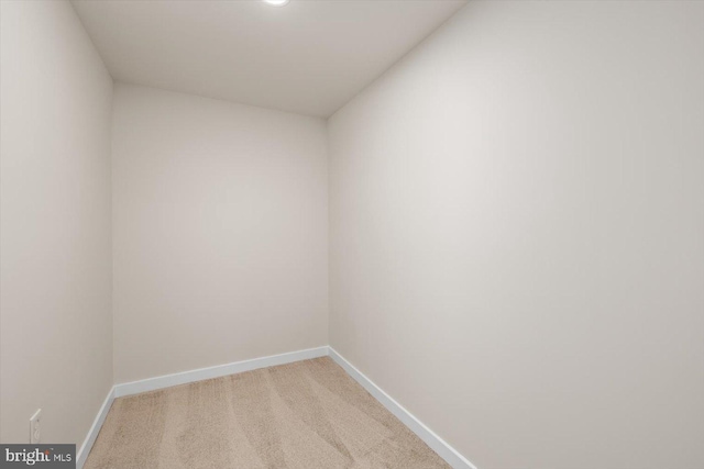 empty room with light carpet and baseboards