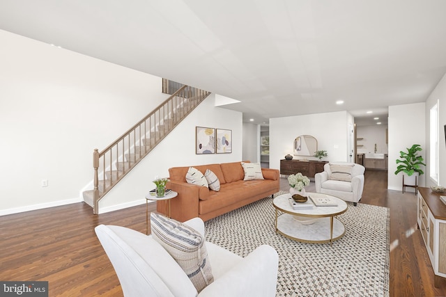 living room with baseboards, recessed lighting, wood finished floors, and stairs