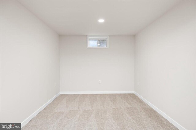 basement with baseboards, recessed lighting, and carpet