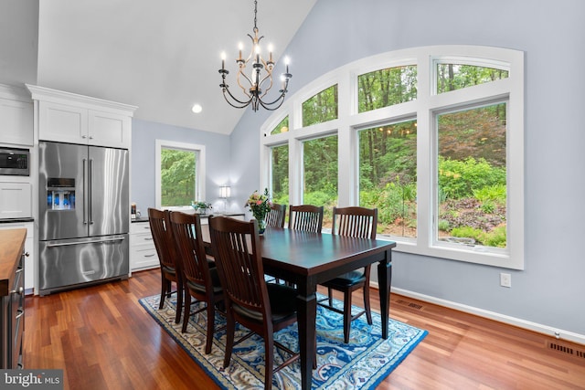 116 Amesbury Ct, Severna Park, MD 21146 - dining room with plenty of natural light, a chandelier, dark wood-style flooring, high vaulted ceiling, and baseboards