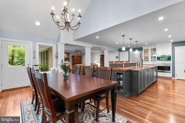 116 Amesbury Ct, Severna Park, MD 21146 - dining area featuring decorative columns, light wood finished floors, recessed lighting, vaulted ceiling, and a chandelier