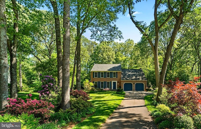 116 Amesbury Ct, Severna Park, MD 21146 - colonial house featuring a garage, driveway, a front lawn, and brick siding