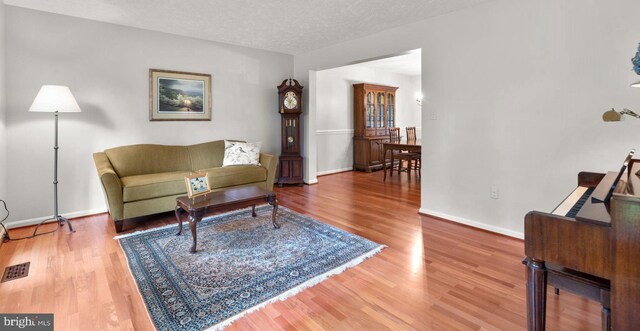 116 Amesbury Ct, Severna Park, MD 21146 - living area with wood finished floors, baseboards, and a textured ceiling