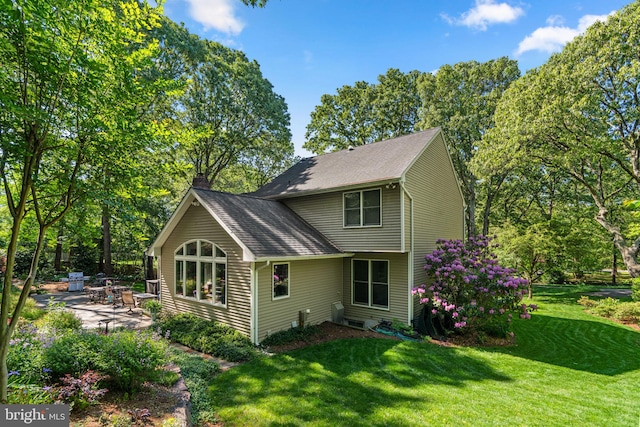 116 Amesbury Ct, Severna Park, MD 21146 - rear view of house featuring a chimney, a patio area, a lawn, and a shingled roof