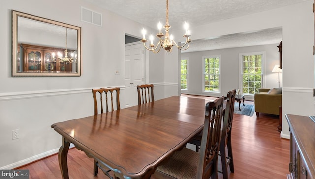 116 Amesbury Ct, Severna Park, MD 21146 - dining space with a chandelier, a textured ceiling, wood finished floors, and baseboards